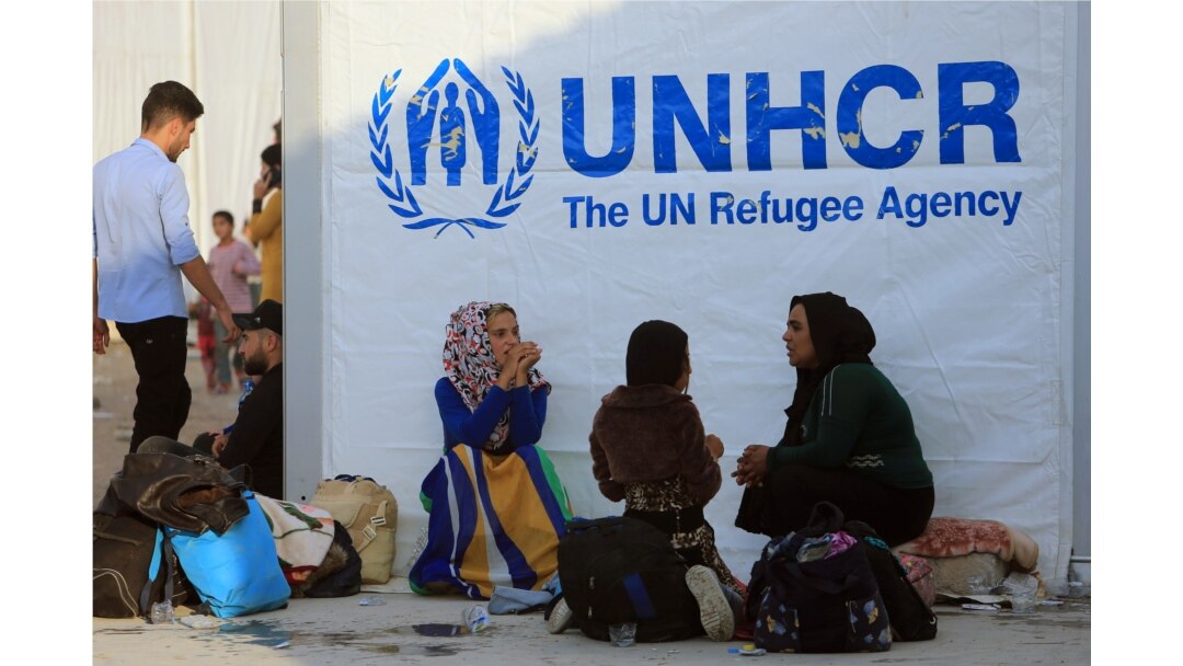 FILE - Syrian displaced families, who fled violence after the Turkish offensive in Syria, sit at a refugee camp in Bardarash on the outskirts of Dohuk, Iraq, Oct. 25, 2019.