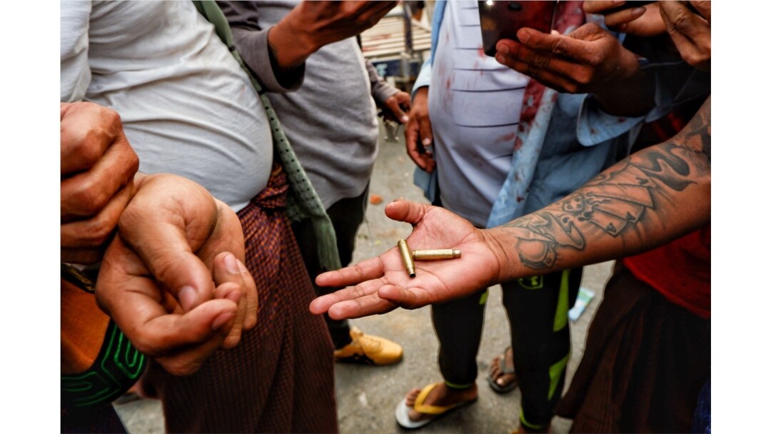 A demonstrator shows bullet shells during a protest against the military coup, in Mandalay, Myanmar, Feb. 20, 2021.