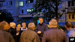 FILE - Belgorod regional governor Vyacheslav Gladkov, center, talks with people on May 12, 2024, after a missile attack. On July 22, 2024, Gladkov said one person was injured when a drone attacked a car in Belgorod.