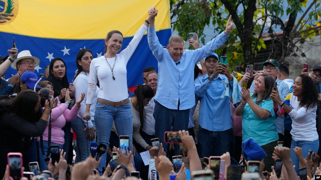 FILE - Venezuelan opposition leader Mariana Corina Machado, center-left, and then-presidential candidate Edmundo Gonzalez Urrutia, acknowledge supporters during a campaign rally in Guatire, Venezuela, May 31, 2024.
