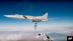 In this photo made from the footage taken from the Russian Defense Ministry official website on Nov. 26, 2017, Russian Tu-22M3 long-range bombers strike Islamic State targets in Syria.