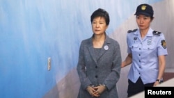 FILE - Ousted South Korean President Park Geun-hye arrives at a court in Seoul, South Korea, Aug. 25, 2017. Geun-hye was eventually jailed for a range of offenses, including corruption and abuse of power.
