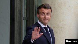 FILE: French President Emmanuel Macron waves at the Elysee Palace in Paris, France. Taken 7.22.2022