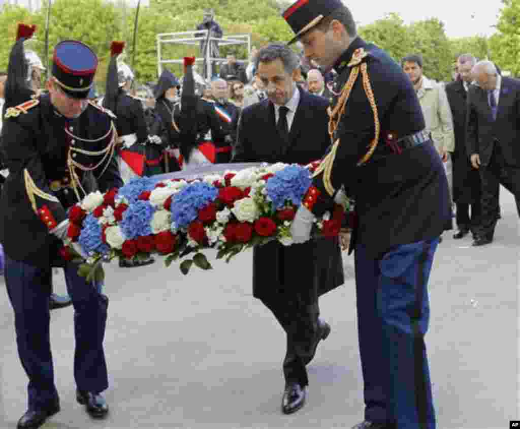 French President and candidate for the French presidential election Nicolas Sarkozy stands before the Armenian Monument during a ceremony marking the 97th anniversary of the Armenian genocide, Tuesday, April. 24, 2012. (AP Photo / Jacques Brinon , Pool