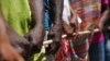 People line up for food aid in Camp Perrin, Haiti, six days after a 7.2 magnitude earthquake hit the area.