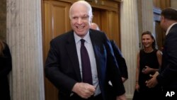 Sen. John McCain, R-Ariz., smiles as he arrives to vote as the Republican-run Senate rejected a GOP proposal to scuttle President Barack Obama's health care law, July 26, 2017, in Washington.