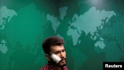 A portrait of Neamat Naghdi, 28 year-old-video reporter for Etilaat Roz newspaper who was beaten by the Taliban during incarceration, at the newspaper office in Kabul, Afghanistan, Sept. 9, 2021.