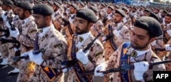 FILE - Members of Iran's Revolutionary Guards Corps (IRGC) march during the annual military parade marking the anniversary of the outbreak of the devastating 1980-1988 war with Saddam Hussein's Iraq, in the capital Tehran, Sept. 22, 2018.