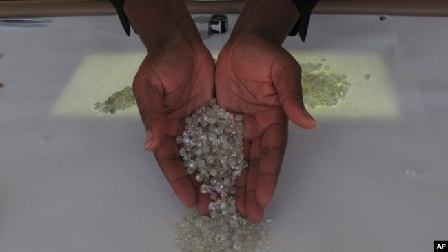 FIST - A worker shows diamonds she is sorting at the Namibia Diamond Trading Company in Windhoek on June 14, 2017. On Feb. 23, 2024, Namibia called for economic sanctions against Israel, a move, which implemented, could affect the nation's diamond industry.
