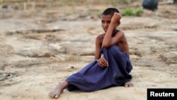 A Rohingya refugee boy sits on the ground at Tang Khali refugee camp near Cox's Bazar, Bangladesh, Oct. 18, 2017. 