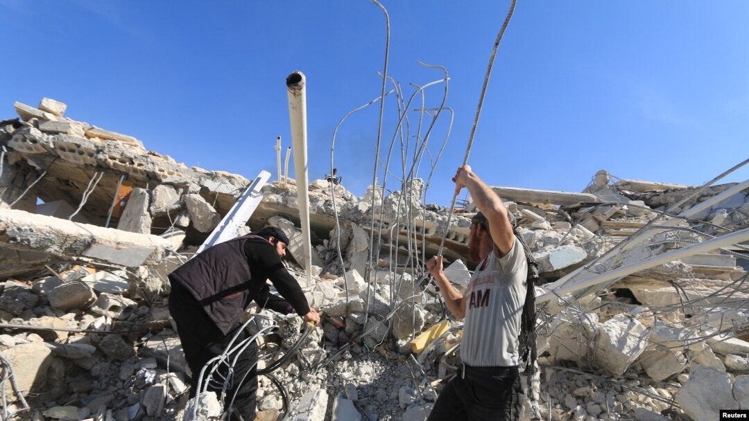 FILE - People look for survivors in the ruins of a destroyed Medecins Sans Frontieres (MSF) supported hospital hit by missiles in Marat Numan, Idlib province, Syria, Feb. 16, 2016. 