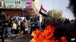 Para demonstran meneriakan slogan dan membakar ban dalam aksi protes menentang kudeta militer di Sudan. Aksi tersebut berlangsung di Khartoum, Sudan, pada 6 Januari 2022. (Foto: AP/Marwan Ali)