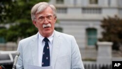 FILE - National security adviser John Bolton speaks to media at the White House in Washington, July 31, 2019. 