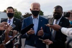 Democratic presidential candidate former Vice President Joe Biden, flanked by members of his Secret Service detail, speaks to media in Charlotte, N.C., Sept. 23, 2020.