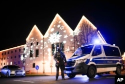 A police officer stands guard at a blocked road near a Christmas market after an incident in Magdeburg, Germany, Dec. 20, 2024.