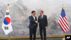 U.S. Secretary of State Antony Blinken, right, and South Korea's National Assembly Speaker Woo Won Shik, left, shake hands during a meeting at the National Assembly in Seoul, Jan. 6, 2025. 