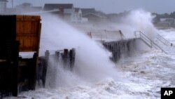 Waves pound a seawall in Montauk, N.Y., Aug. 22, 2021, as Tropical Storm Henri affects the Atlantic coast.