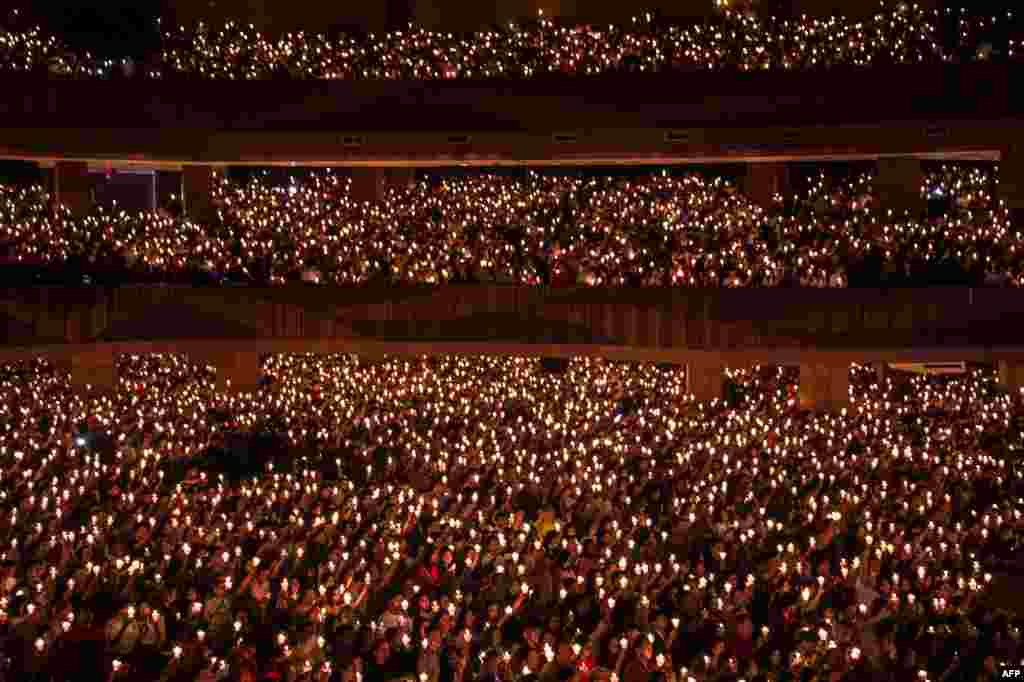 Christians hold candles during a Christmas Eve prayer at a church in Surabaya, East Java, Indonesia.