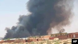 This photo provided by Organization for the General Coordination of Camps for Displaced and Refugees, smoke rises from Abu Zar camp for displaced persons in West Darfur, Sudan, April 6, 2021. 