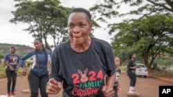 Mellisa Sachitongo, 65, exercises with the Commandos Fitness Club at the Warren Hills cemetery in Harare, Zimbabwe, Saturday, Jan. 18, 2025. ( AP Photo/Aaron Ufumeli)