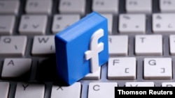 FILE PHOTO: A 3D-printed Facebook logo is seen placed on a keyboard in this illustration