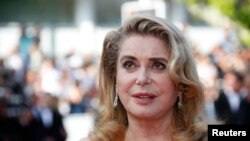 FILE - Actress Catherine Deneuve pose on the Red Carpet at the 72nd Cannes Film Festival in Cannes, France, May 25, 2019