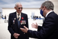 Lord Edward Llewellyn, British ambassador to France, speaks with veteran David Mylchreest, 97, after the official opening ceremony of the British Normandy Memorial at Ver-sur-Mer, on the 77th anniversary of D-Day, France, June 6, 2021.