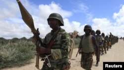 FILE - African Union Mission in Somalia (AMISOM) soldiers from Burundi patrol on the outskirts of Mogadishu, Somalia, May 22, 2012.