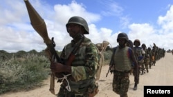 FILE - African Union Mission in Somalia (AMISOM) soldiers from Burundi patrol on the outskirts of Mogadishu, Somalia, May 22, 2012.