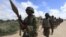 FILE - African Union Mission in Somalia (AMISOM) soldiers from Burundi patrol on the outskirts of Mogadishu, Somalia, May 22, 2012.