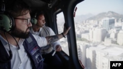 This handout picture released by the Chilean Presidency shows Chile's President Gabriel Boric flying over Santiago in a helicopter during a blackout on Feb. 25, 2025.