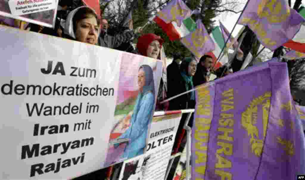 Activists of the Iranian Resistance Council shout slogans against the government in Iran during a demonstration in front of the Iranian embassy in Berlin, Germany, Tuesday, Feb. 15, 2011. Poster reads "Yes to a democratic change in Iran with Maryam Rajavi