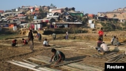 FILE - Rohingya refugees build shelter with bamboo at the Jamtoli camp in the morning in Cox's Bazar, Bangladesh, Jan. 22, 2018.