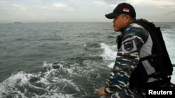 Navy personnel look for survivors Thursday during a search and rescue operation after a boat carrying Indonesian migrant workers capsized off Batam Wednesday, near Nongsa, Batam, Indonesia. 