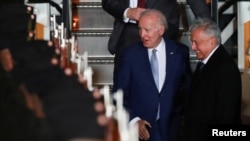 U.S. President Joe Biden is greeted by Mexico's President Andres Manuel Lopez Obrador as he arrives at the Felipe Angeles International Airport, to attend the North American Leaders' Summit, in Santa Lucia, Mexico Jan. 8, 2023. 