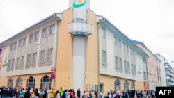 FILE - People showing their sympathy to muslims stand outside the mosque at the Islamic Cultural Centre in Oslo on August 11, 2019, one day after a gunman armed with multiple weapons had opened fire in a mosque.