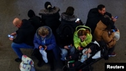 People take shelter inside a metro station during a Russian military strike, amid Russia's attack on Ukraine, in Kyiv, Ukraine Jan. 15, 2025. 