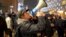 In this image taken from video, demonstrators protest against government restrictions implemented because of the coronavirus pandemic, Nov. 19, 2021, in Rotterdam, Netherlands.