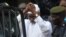 FILE - Former Chadian dictator Hissene Habre is escorted by military officers after being heard by a judge on Jul. 2, 2013 in Dakar, Senegal.