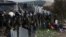 Macedonian policemen guard the borders of their country as an army truck arrives to build a border fence to prevent illegal crossings by migrants, in the Greek-Macedonian border near the Greek village of Idomeni, Nov. 28, 2015. 