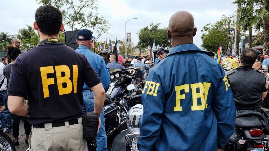 FILE - FBI agents look on as the gay pride parade kicks off in West Hollywood, Calif., June 12, 2016. 