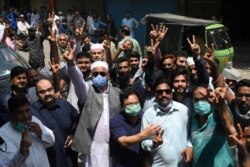 Traders gesture as they protest near their closed shops against a coronavirus lockdown imposed by the Punjab provincial government ahead of the Muslim festival Eid-al-Adha, in Lahore, Pakistan, July 28, 2020.