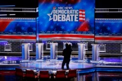 FILE - A cameraman walks across the stage during setup for the Nevada Democratic presidential debate in Las Vegas, Feb. 18, 2020.