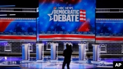 A cameraman walks across the stage during setup for the Nevada Democratic presidential debate Tuesday, Feb. 18, 2020, in Las Vegas.
