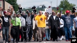 Muchos ciudadanos del suburbio de Ferguson se manifestaron el lunes frente a la sede de la policía por la muerte del adolescente Michael Brown.