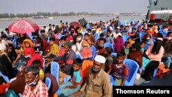 File: Rohingya refugees are seen aboard a ship as they are moved to Bhasan Char island, Bangladesh.