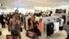 FILE - Shoppers react during the opening of the Mall of Africa in Midrand, outside Johannesburg, South Africa, April 28, 2016. 