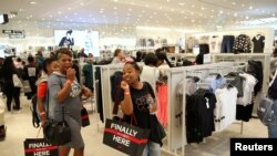 FILE - Shoppers react during the opening of the Mall of Africa in Midrand, outside Johannesburg, South Africa, April 28, 2016. 