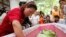 Thai family members gather around the coffin of a victim of the Erawan Shrine bombing at a hospital in Bangkok, Thailand,  Aug. 18, 2015. 