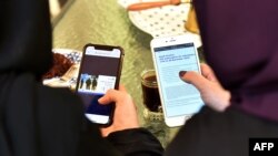 Women in Saudi Arabia's capital Riyadh checking on their mobile phones, November 27, 2019.